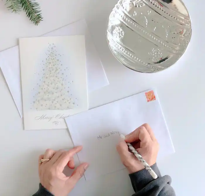 Addressing their Christmas Greeting Card envelope