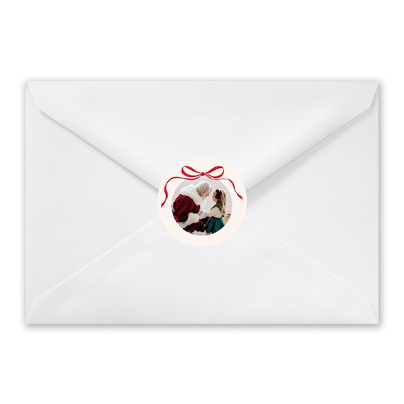 white envelope with circular photo area and red bow seal