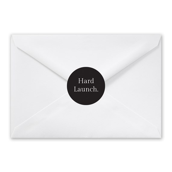 white envelope with black round seal and text