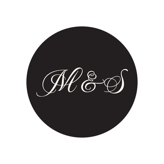 black circular seal with white lettering M & S