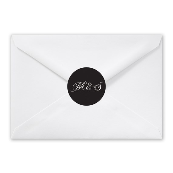 white envelope with black seal and cursive text