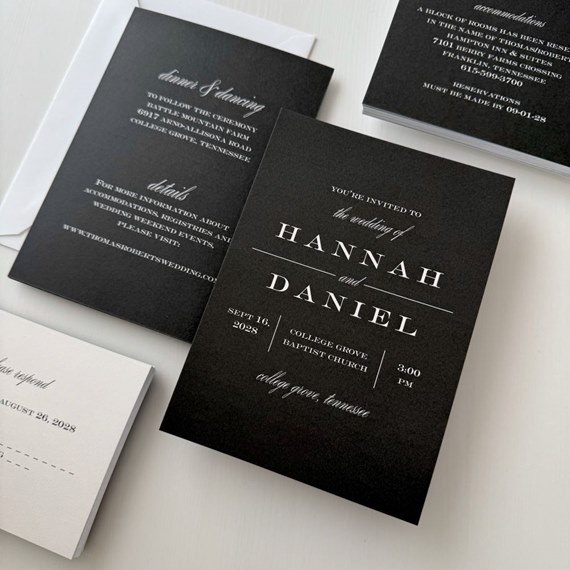 black wedding invitation with white text and RSVP postcard