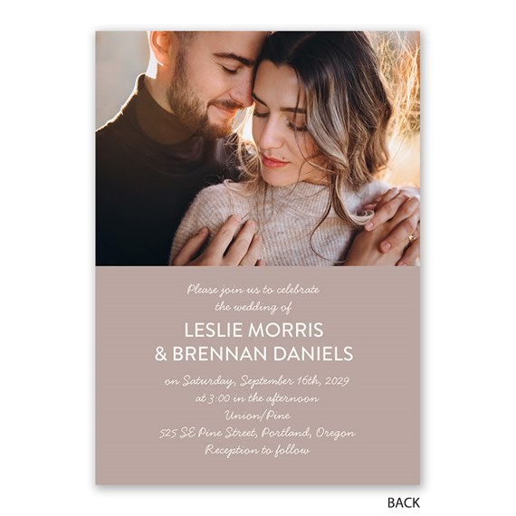 Photo wedding invitation with close-up couple portrait above event text on a muted blush-beige background
