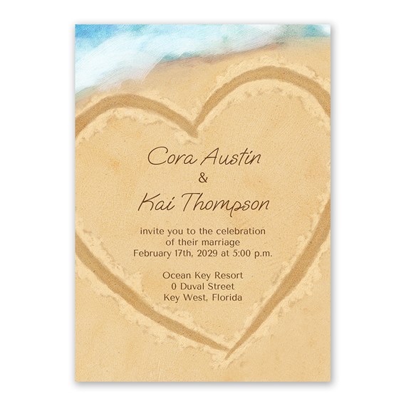 beach-themed wedding invitation with heart in sand and blue sky
