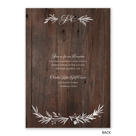 wooden wedding invitation with floral accents and reception details