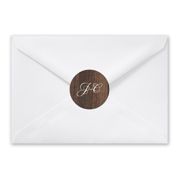 white envelope with wood texture seal and monogram