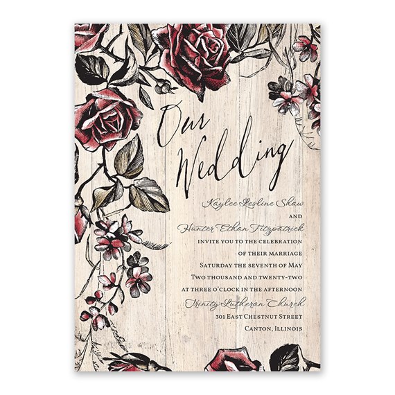 wedding invitation with floral design and wood background