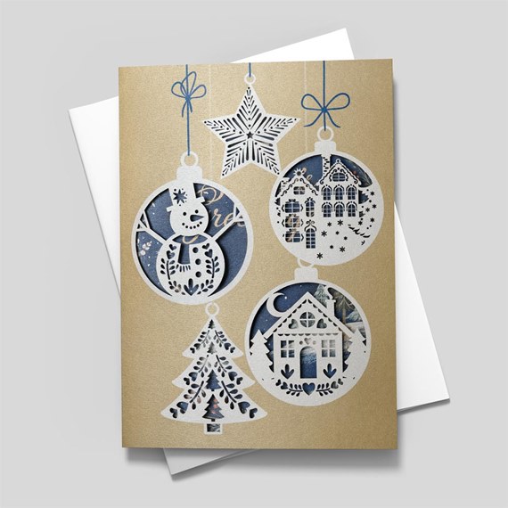 decorative ornaments with snowman, house, tree, and star on gold background