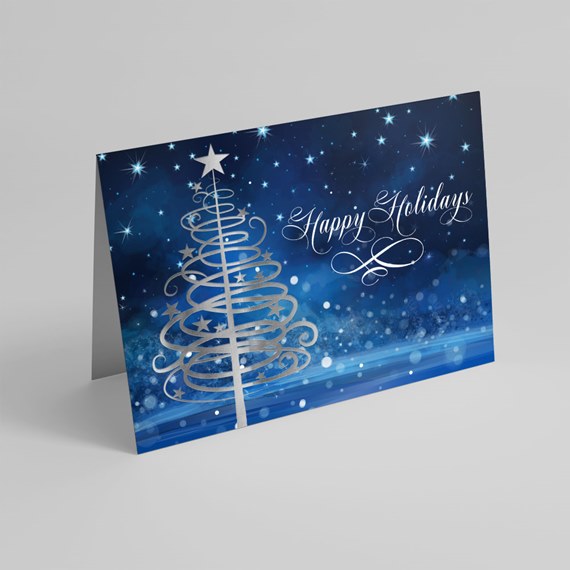 Folded holiday card featuring a spiral silver Christmas tree and 'Happy Holidays' script on a blue starry background
