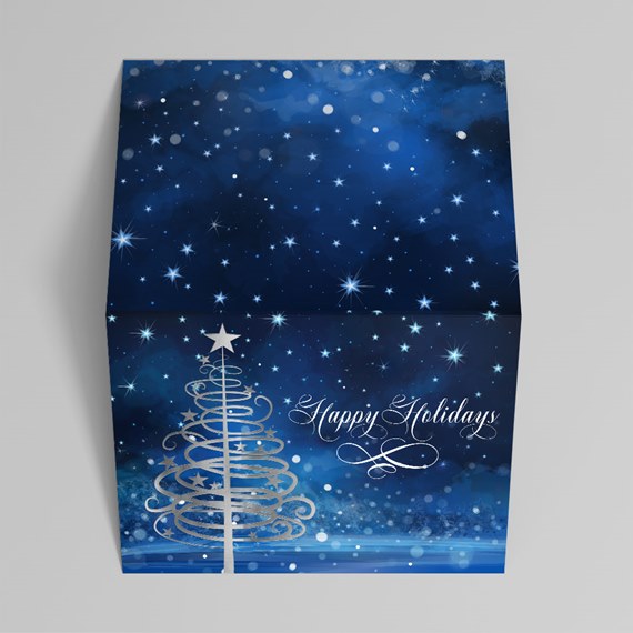 Blue holiday greeting card with starry night design, silver swirl Christmas tree and 