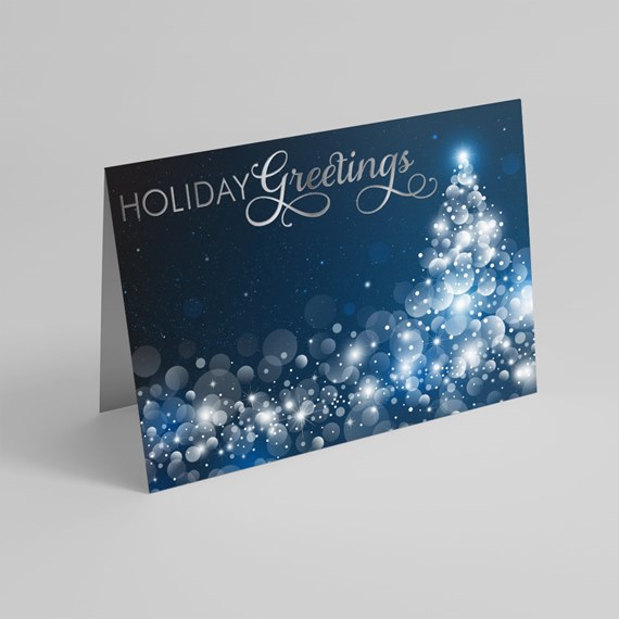 Folded holiday card with dark blue background, white bokeh lights forming a tree and 'Holiday Greetings' text