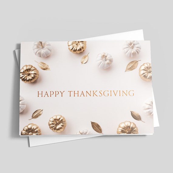 Thanksgiving card with white and gold pumpkins and gold leaves and centered 