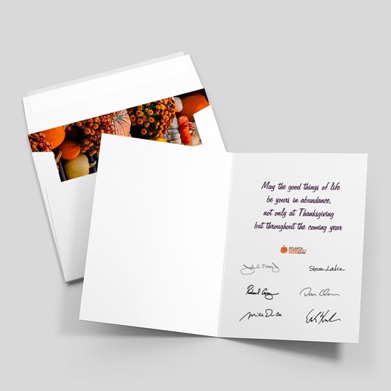 Folded Thanksgiving greeting card and white envelope with interior message and pumpkin photo accent