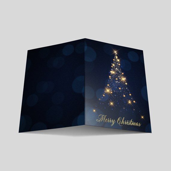 Folded navy Christmas card with gold starry tree and 'Merry Christmas' greeting