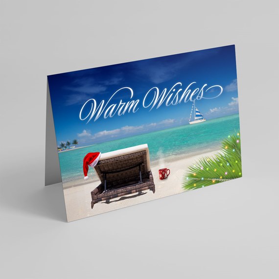 beach scene with lounge chair, Santa hat, and text