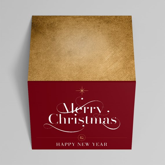Square gift box with gold textured top and burgundy sides reading Merry Christmas and Happy New Year in white script