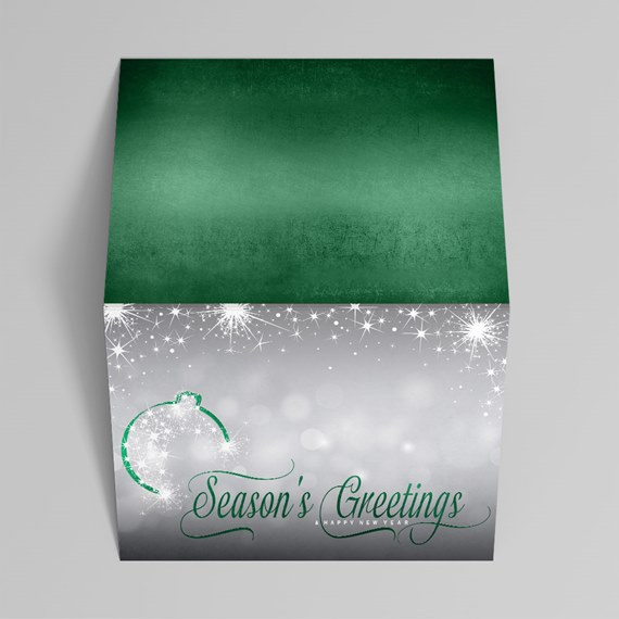 Folded silver-gray holiday card with green interior, star sparkles, ornament outline and "Season's Greetings" script