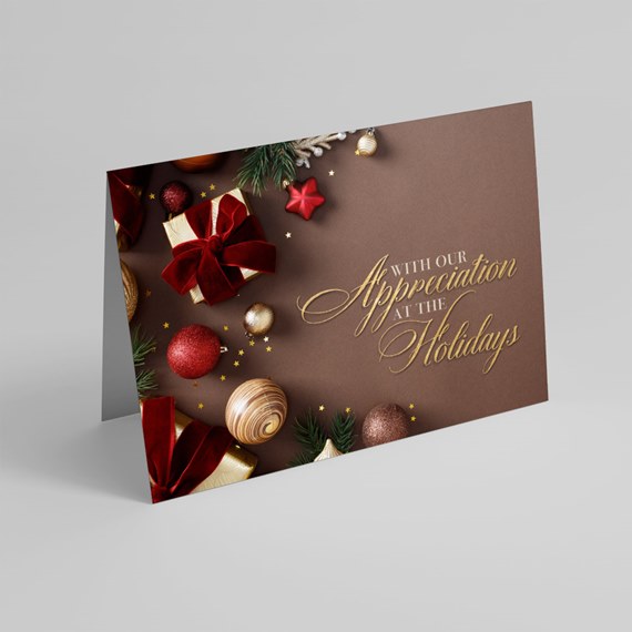 folded brown holiday greeting card with gold script and red and gold ornaments