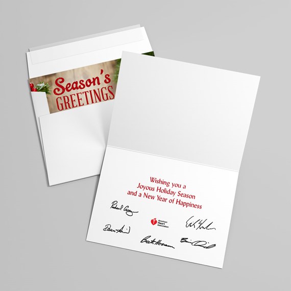 folded white holiday greeting card and envelope with red interior message and printed signatures