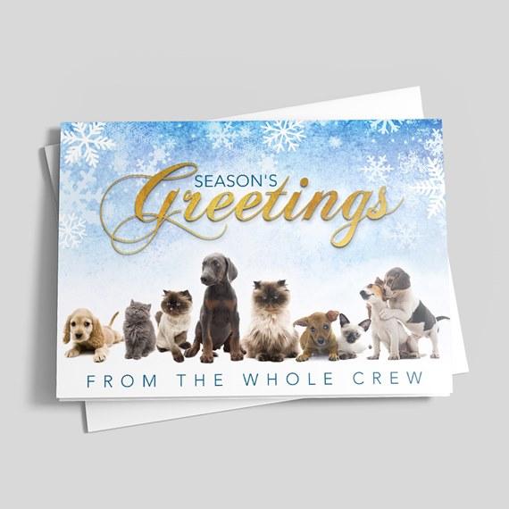 Holiday greeting card with puppies and kittens, gold "Season's Greetings" script and blue snowflake background