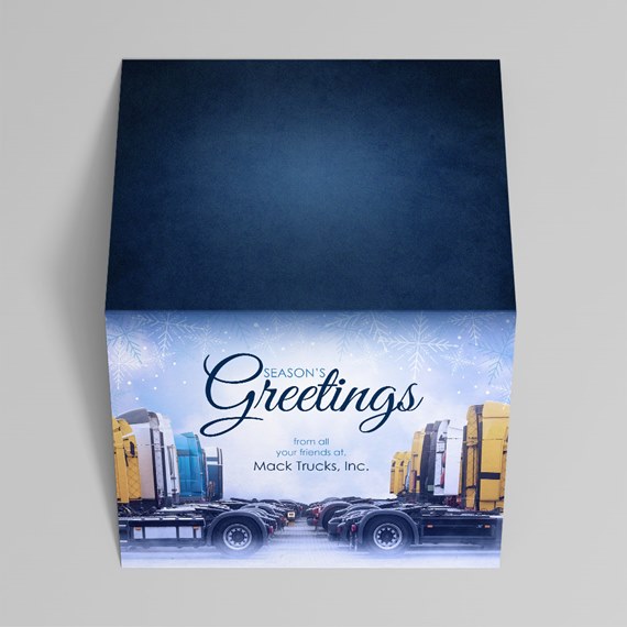 Holiday gift box with navy lid and printed trucks, snowflakes and greeting text
