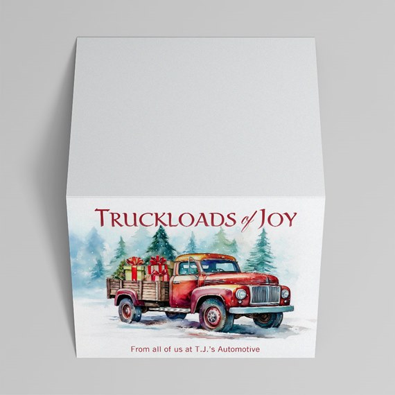 White square gift box with watercolor red pickup truck carrying gifts and pine trees in a snowy holiday scene