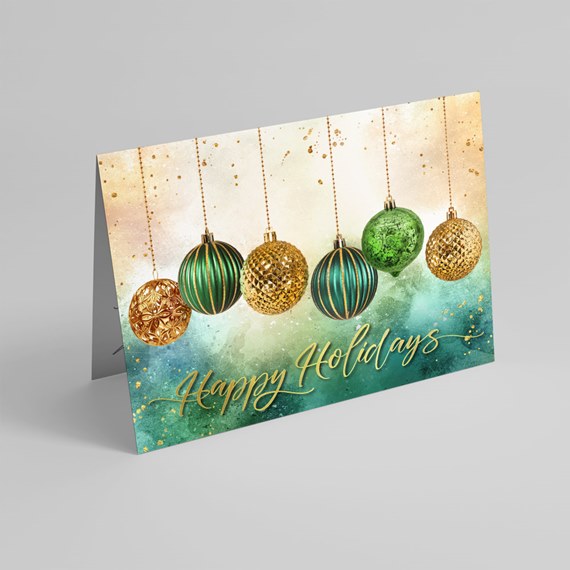 Folded holiday greeting card with green and gold hanging ornaments and gold "Happy Holidays" text