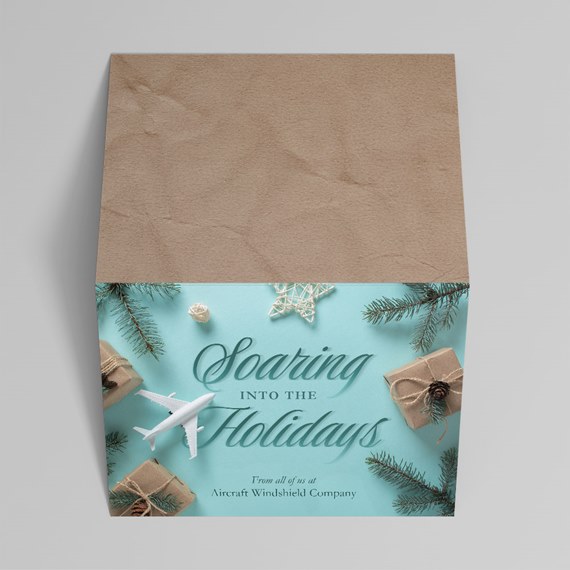holiday gift box with teal panel, airplane motif, wrapped gifts and pine sprigs