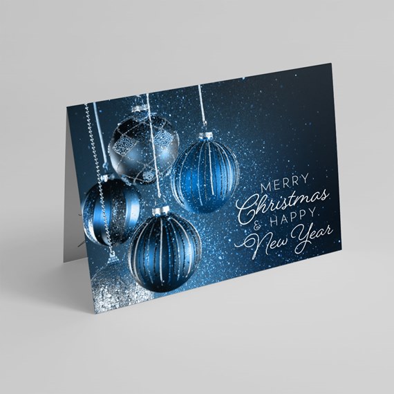 Folded Christmas card with blue hanging baubles and white script greeting