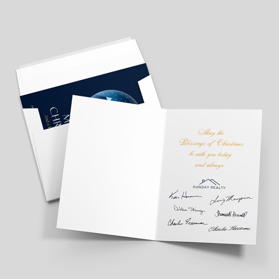 open white holiday greeting card with gold script, navy logo, signatures and envelopes