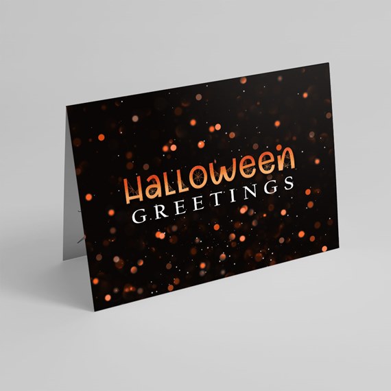 black greeting card with orange and white bokeh, Halloween text
