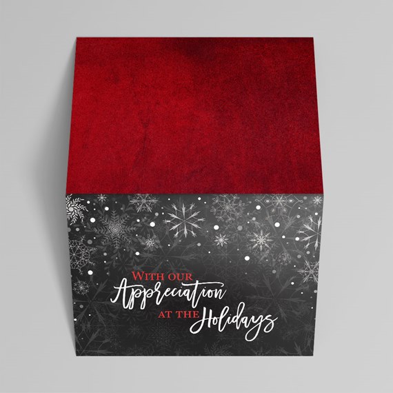 red and black gift box with snowflake design and message
