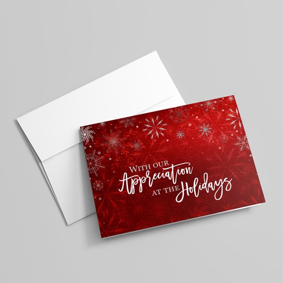 red holiday card with snowflakes and text