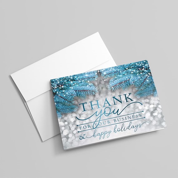 greeting card design with blue pine branches and text