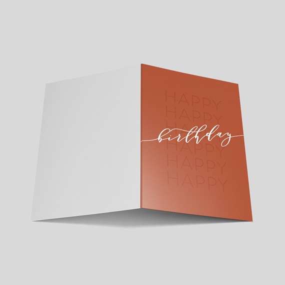 folded birthday card with terracotta front and white handwritten text