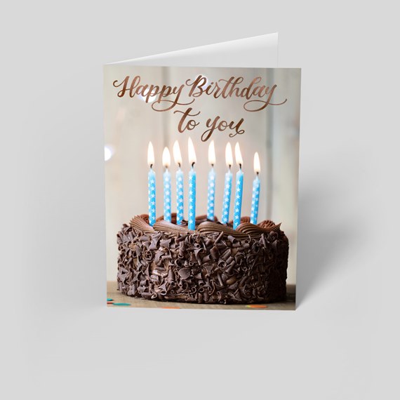 chocolate cake with candles and birthday text