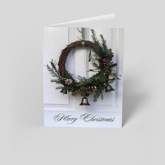 Christmas wreath with bells and 'Merry Christmas' text