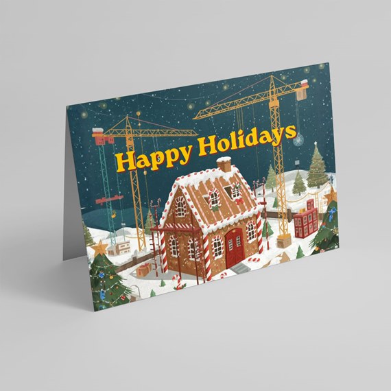 holiday card with gingerbread house and construction cranes