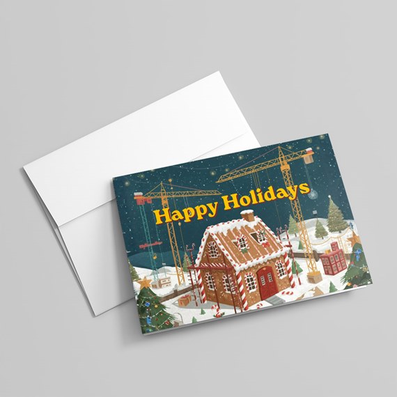 holiday card with gingerbread house and construction cranes