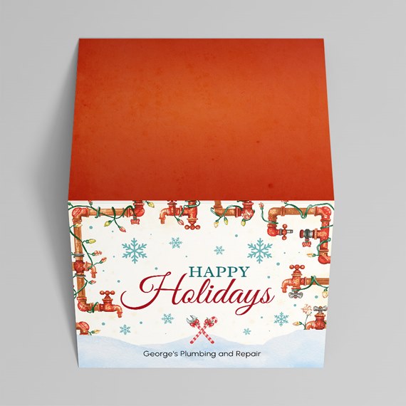 holiday-themed box with plumbing illustrations and customizable text area