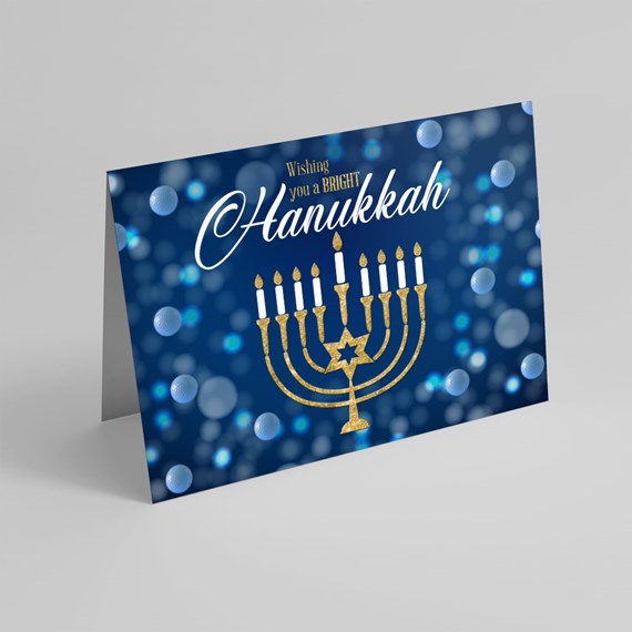 Hanukkah greeting card with menorah and bokeh background