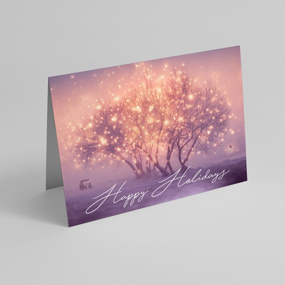 holiday card with tree lights and script text