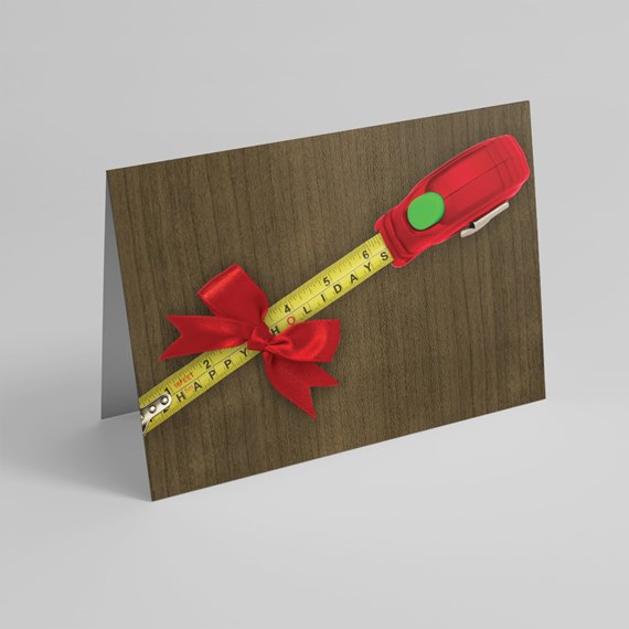 folded wood-grain greeting card with yellow measuring tape, red bow and red tape-measure casing