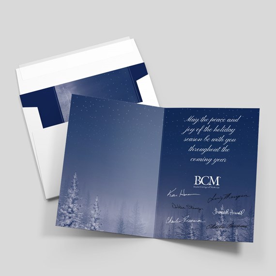 holiday card with snowy trees and text
