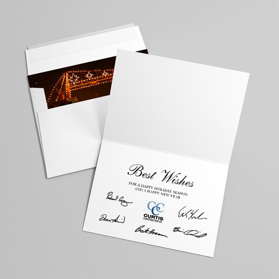 folded corporate greeting card with printed signatures and envelope with photo insert