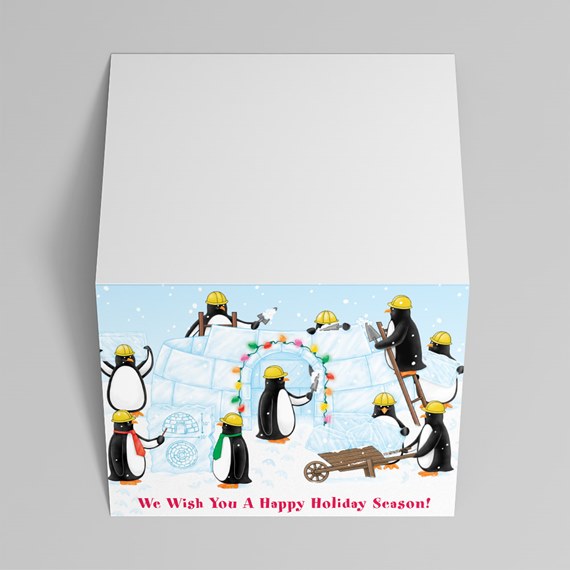 holiday card design with penguins building an ice structure