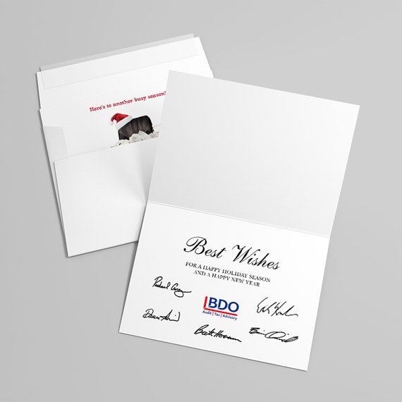 open folded white holiday greeting card with envelopes, printed "Best Wishes" message and multiple printed signatures