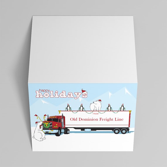 holiday gift box top showing a red semi truck and white trailer with penguins and polar bears in a snowy mountain illustration and 'happy holidays' text