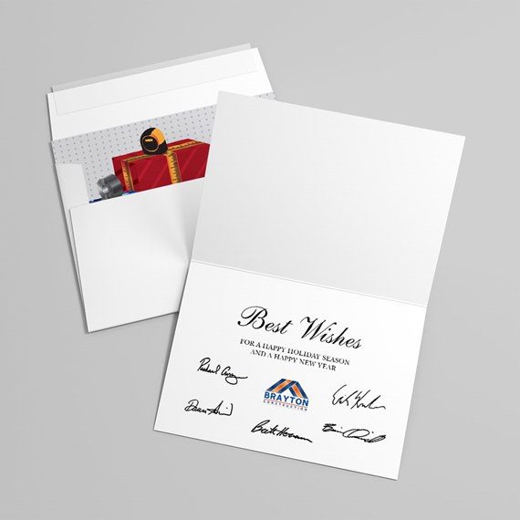 folded white greeting card with 'Best Wishes' text, signatures and logo, shown with envelope and gift illustration