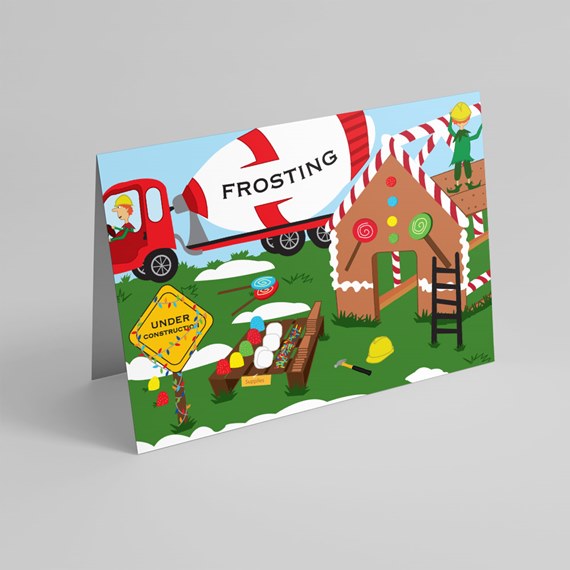 Folded greeting card showing a cartoon gingerbread house under construction with a frosting truck and candy decorations